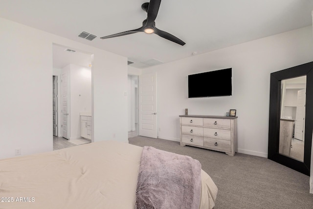 bedroom featuring ceiling fan, light carpet, and ensuite bath