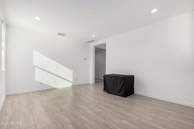 empty room with light hardwood / wood-style flooring