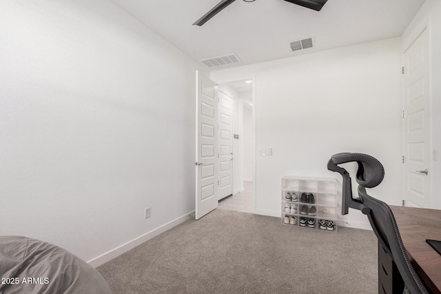 exercise room featuring ceiling fan and light colored carpet