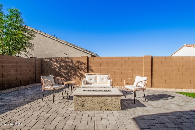 view of patio featuring an outdoor living space with a fire pit