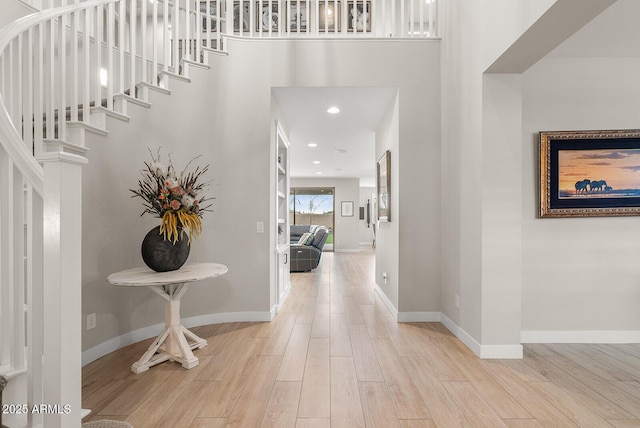 corridor featuring recessed lighting, baseboards, and wood finished floors