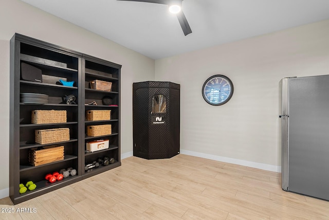 interior space with baseboards, light wood-type flooring, and ceiling fan