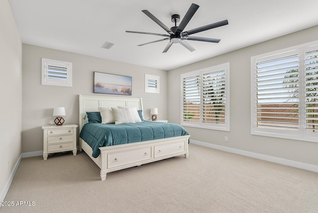 bedroom featuring visible vents, light colored carpet, baseboards, and ceiling fan