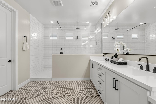 full bath featuring visible vents, walk in shower, and a sink