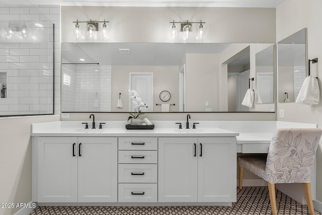 full bath featuring double vanity, tiled shower, and a sink