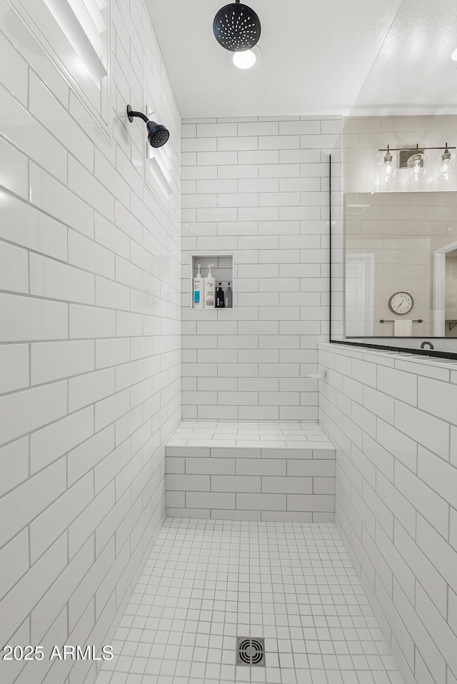 bathroom with a tile shower