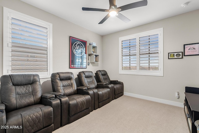 home theater featuring carpet, baseboards, and ceiling fan