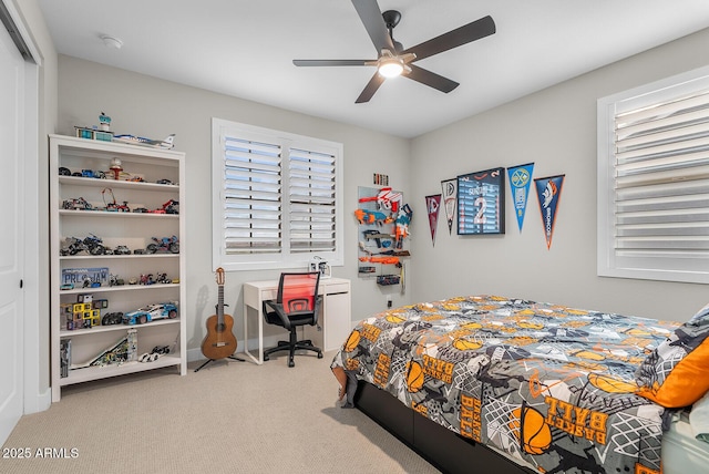 carpeted bedroom with a ceiling fan, a closet, and baseboards