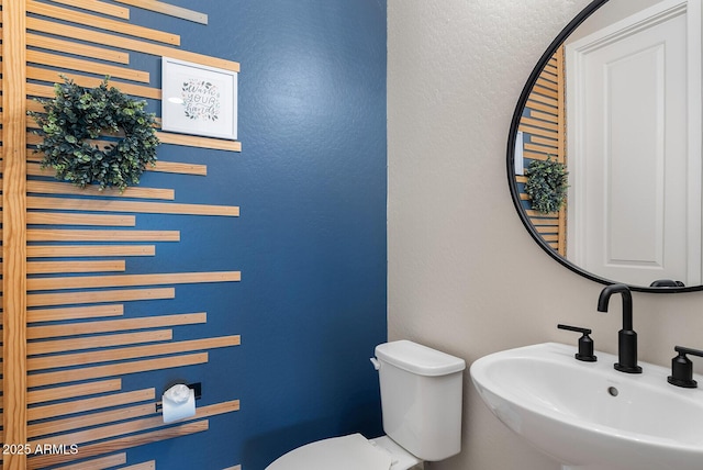 bathroom with toilet and a sink