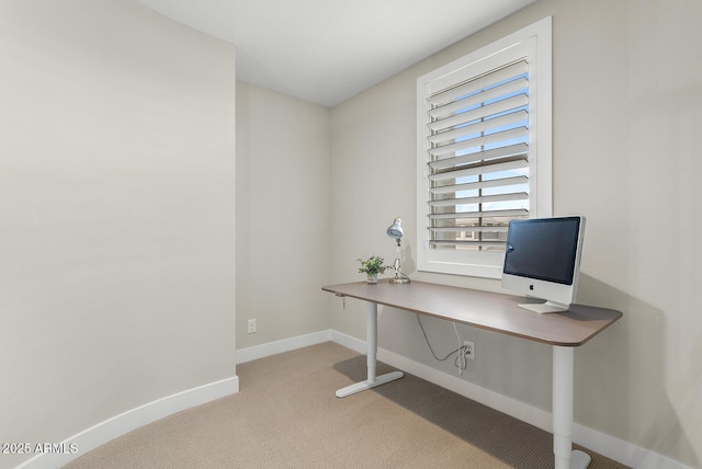 carpeted office featuring baseboards