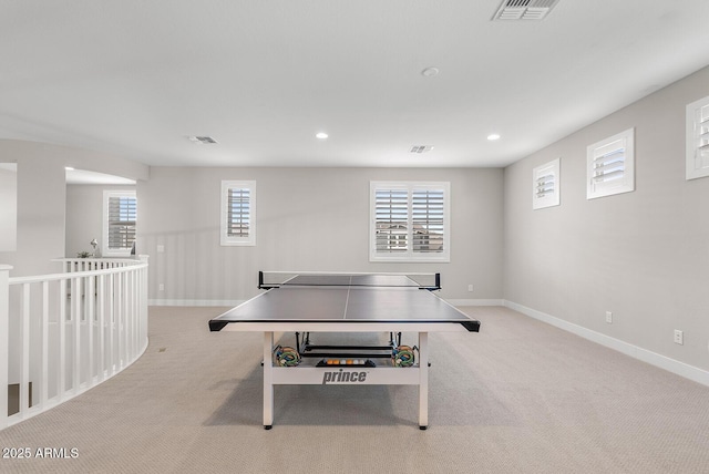 rec room featuring light colored carpet, visible vents, and baseboards