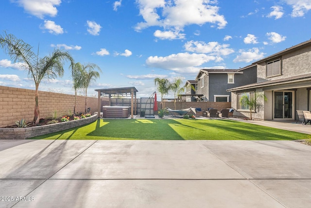 view of yard with a hot tub, a fenced backyard, and a patio area