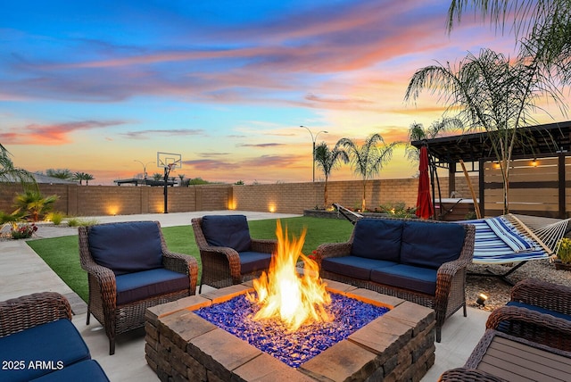 view of patio featuring an outdoor living space with a fire pit and a fenced backyard