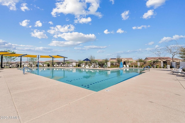 pool with a residential view, fence, and a patio area