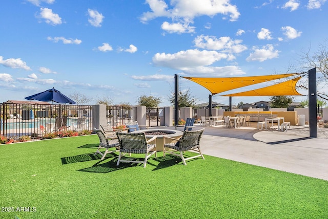 view of yard featuring a patio area, a fire pit, and fence