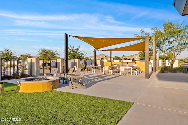 view of patio with a fire pit and fence