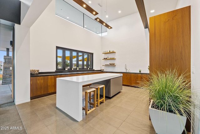 bar featuring light tile patterned floors, recessed lighting, a towering ceiling, and a sink