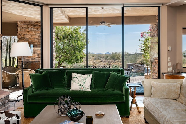 living room featuring ceiling fan and plenty of natural light