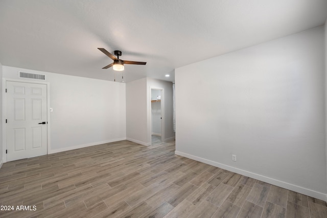 unfurnished room with ceiling fan and light wood-type flooring