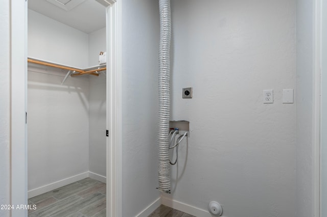 laundry room featuring washer hookup, hookup for an electric dryer, and light hardwood / wood-style flooring