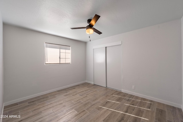 spare room with wood-type flooring, a textured ceiling, and ceiling fan