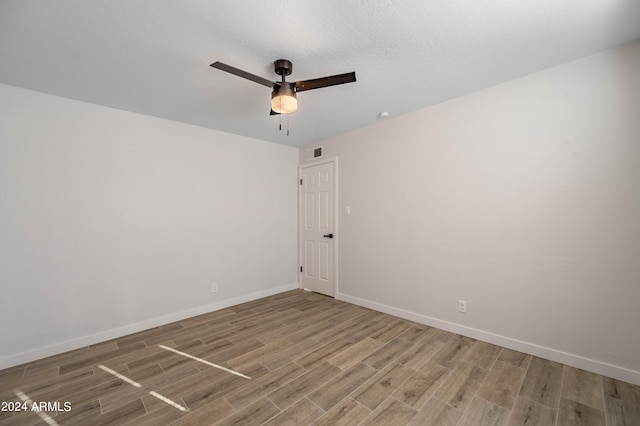 empty room featuring wood-type flooring and ceiling fan