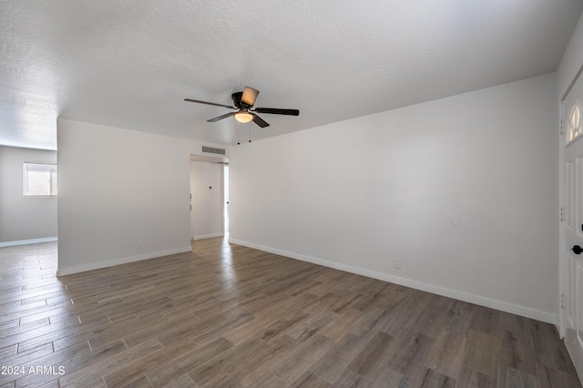 spare room with ceiling fan, hardwood / wood-style floors, and a textured ceiling