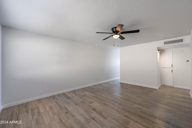 spare room featuring a textured ceiling, ceiling fan, and hardwood / wood-style flooring