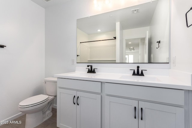 bathroom with walk in shower, vanity, and toilet