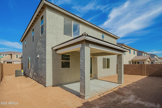 rear view of house featuring central AC unit and a patio area