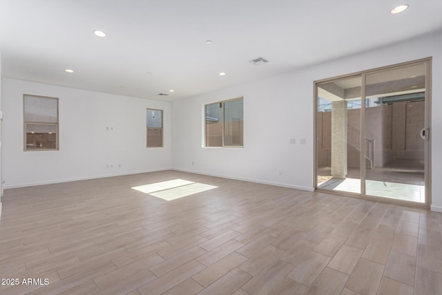 unfurnished room with light hardwood / wood-style flooring and a wealth of natural light