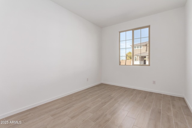 spare room featuring light wood-type flooring