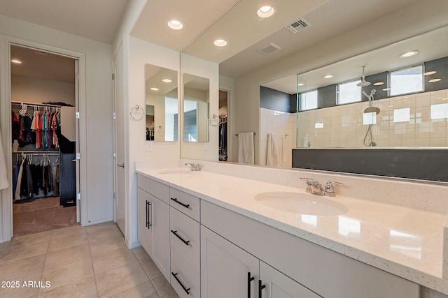 bathroom featuring a shower, vanity, and tile patterned flooring