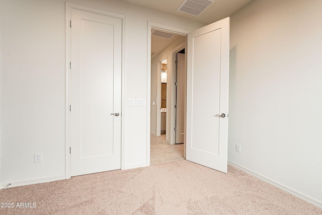 unfurnished bedroom featuring light colored carpet