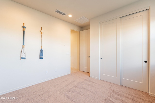 unfurnished bedroom with a closet and carpet floors