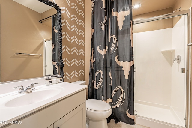 bathroom featuring walk in shower, vanity, and toilet