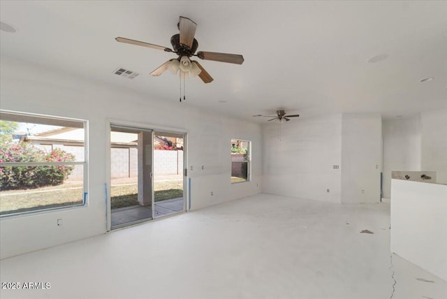 spare room featuring a ceiling fan, visible vents, and concrete flooring