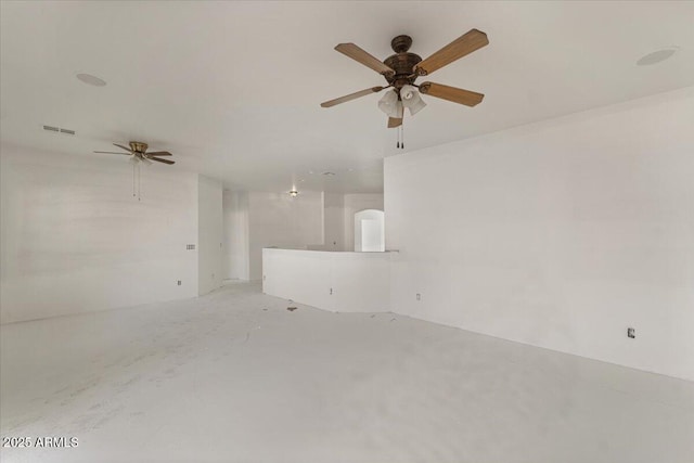 empty room featuring ceiling fan, visible vents, and concrete flooring