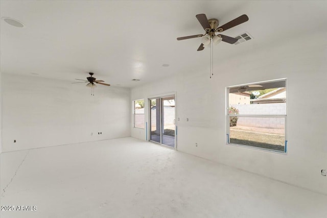 empty room with concrete flooring, ceiling fan, and visible vents