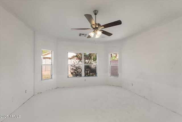 unfurnished room featuring a healthy amount of sunlight, visible vents, and a ceiling fan