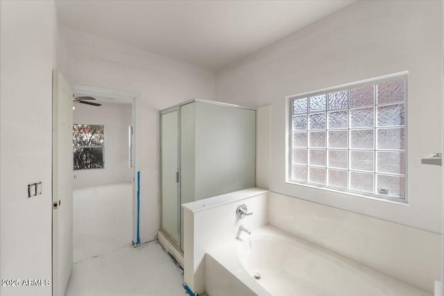 bathroom with a garden tub, ceiling fan, a shower stall, and a wealth of natural light