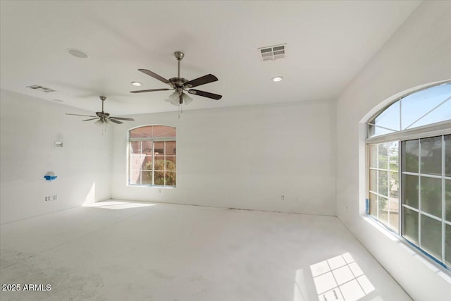 empty room with recessed lighting, visible vents, and a healthy amount of sunlight