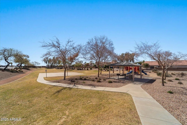 view of community with playground community and a yard