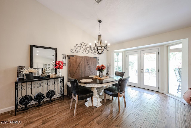 9085 E Windrose Dr, Scottsdale, AZ 85260 - dining area with french doors, a chandelier, wood finished floors, and lofted ceiling