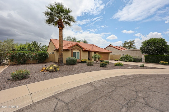 9085 E Windrose Dr, Scottsdale, AZ 85260 - mediterranean / spanish-style home featuring a garage, a tile roof, driveway, and stucco siding