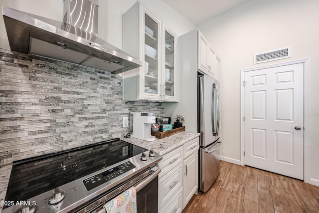9085 E Windrose Dr, Scottsdale, AZ 85260 - kitchen with exhaust hood, stainless steel appliances, decorative backsplash, and white cabinets