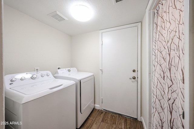 9085 E Windrose Dr, Scottsdale, AZ 85260 - washroom featuring washing machine and dryer and dark wood-style floors