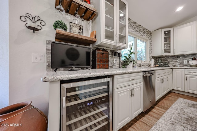 9085 E Windrose Dr, Scottsdale, AZ 85260 - kitchen featuring beverage cooler, dishwasher, backsplash, light wood finished floors, and white cabinetry