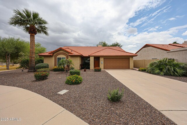 9085 E Windrose Dr, Scottsdale, AZ 85260 - mediterranean / spanish-style house with stucco siding, a tiled roof, a garage, and driveway