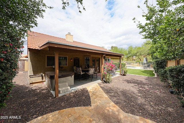 9085 E Windrose Dr, Scottsdale, AZ 85260 - rear view of house with a patio area, a chimney, a fenced backyard, a tiled roof, and a hot tub